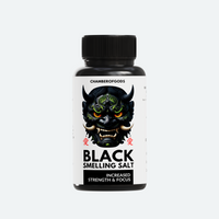A black bottle labeled 'Black Smelling Salt' by Chamberofgods, featuring a bold and menacing design with a demonic face. The label highlights the product's purpose: 'Increased Strength & Focus.' The text is complemented by red accents, emphasizing its intensity and effectiveness.