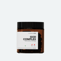 A brown jar labeled 'God Complex' by Chamberofgods, featuring a minimalist design with the tagline 'Multivitamin for Gods.' The label includes a small geometric icon and indicates that it provides 60 servings.