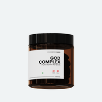 A brown jar labeled 'God Complex' by Chamberofgods, featuring a minimalist design with the tagline 'Multivitamin for Gods.' The label includes a small geometric icon and indicates that it provides 60 servings.